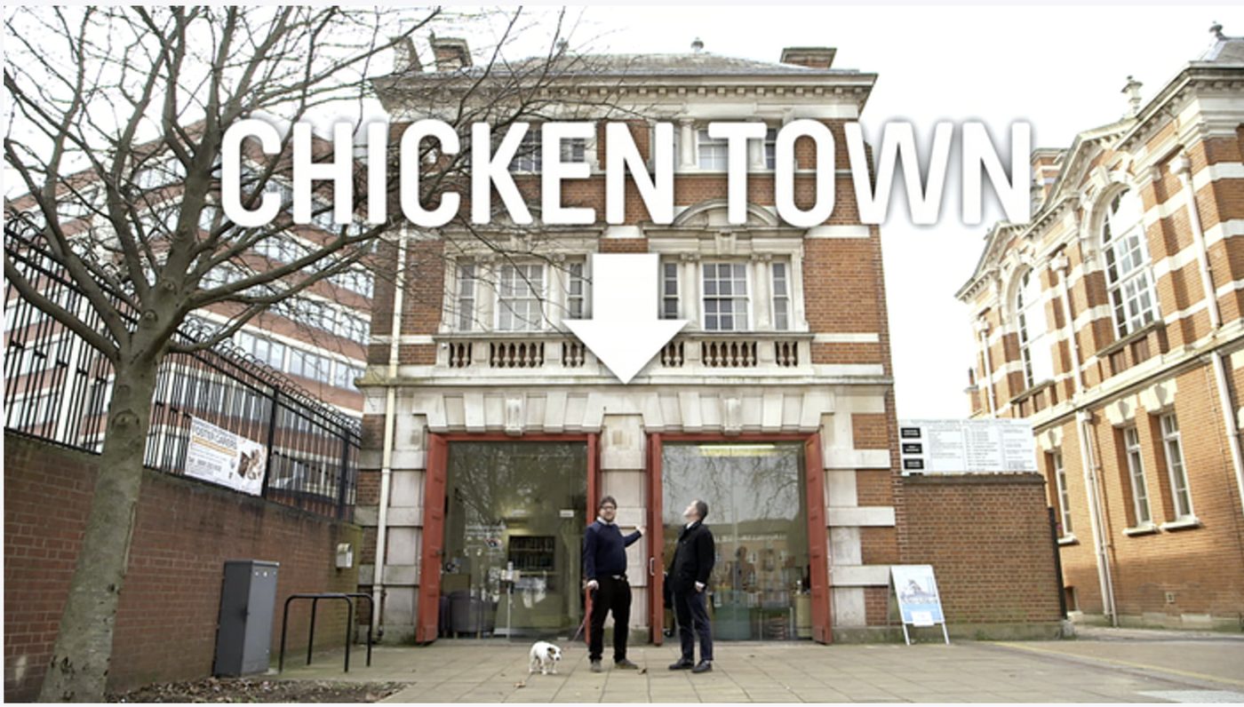 Chicken Town's entrance, the converted Grade II-listed former fire station on Tottenham Green, with the Chicken Town title card from the original Kickstarter campaign video.